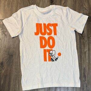 Nike Kids White Tee with Orange 'Just Do It' Graphic